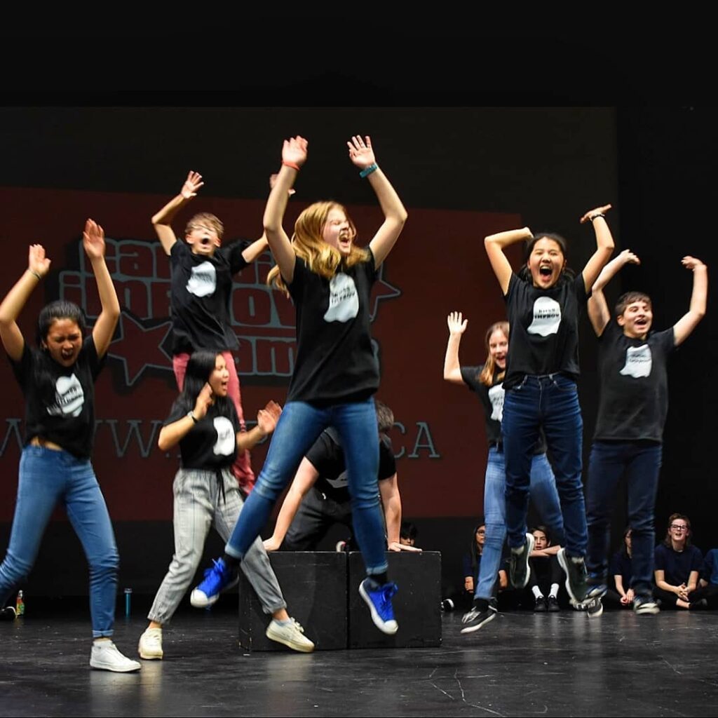 Maelle McCallum performing on stage with a group of her peers.