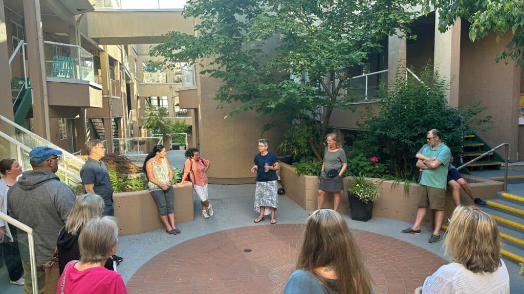 Tour participants gather in the courtyard of Wits End Housing Co-operative on July 12, 2023.