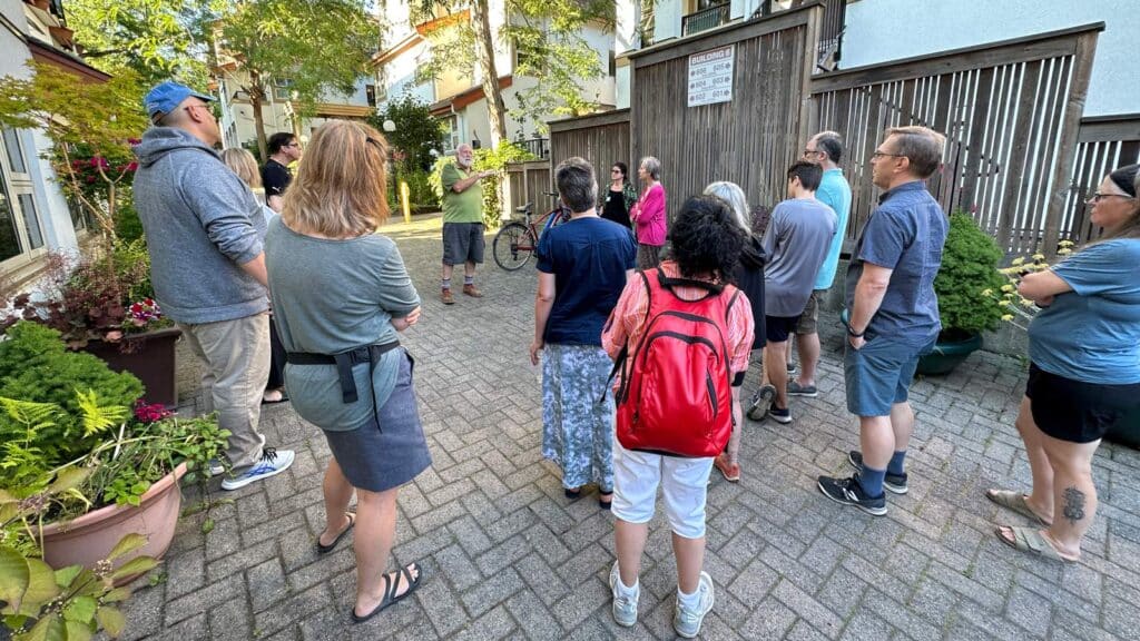 Tour participants learn about Marine Court Housing Co-operative on July 12, 2023.