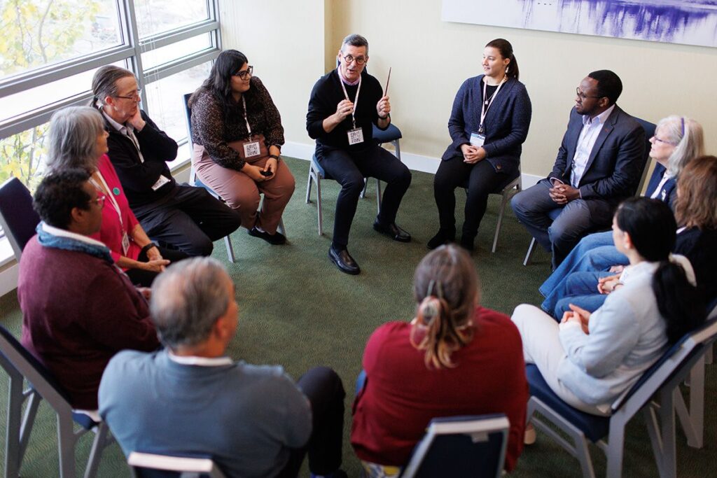 Attendees seated in a circle for a small-group discussion at a CHF BC conference