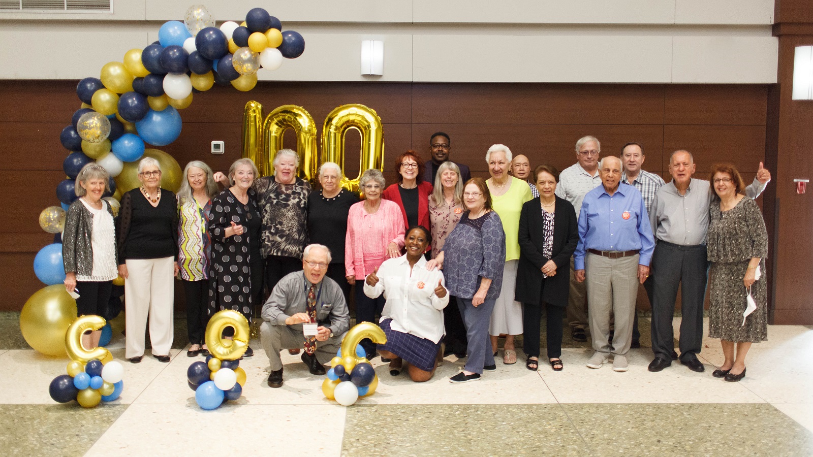 Group of members celebrating CHF BC's 100th milestone with balloons