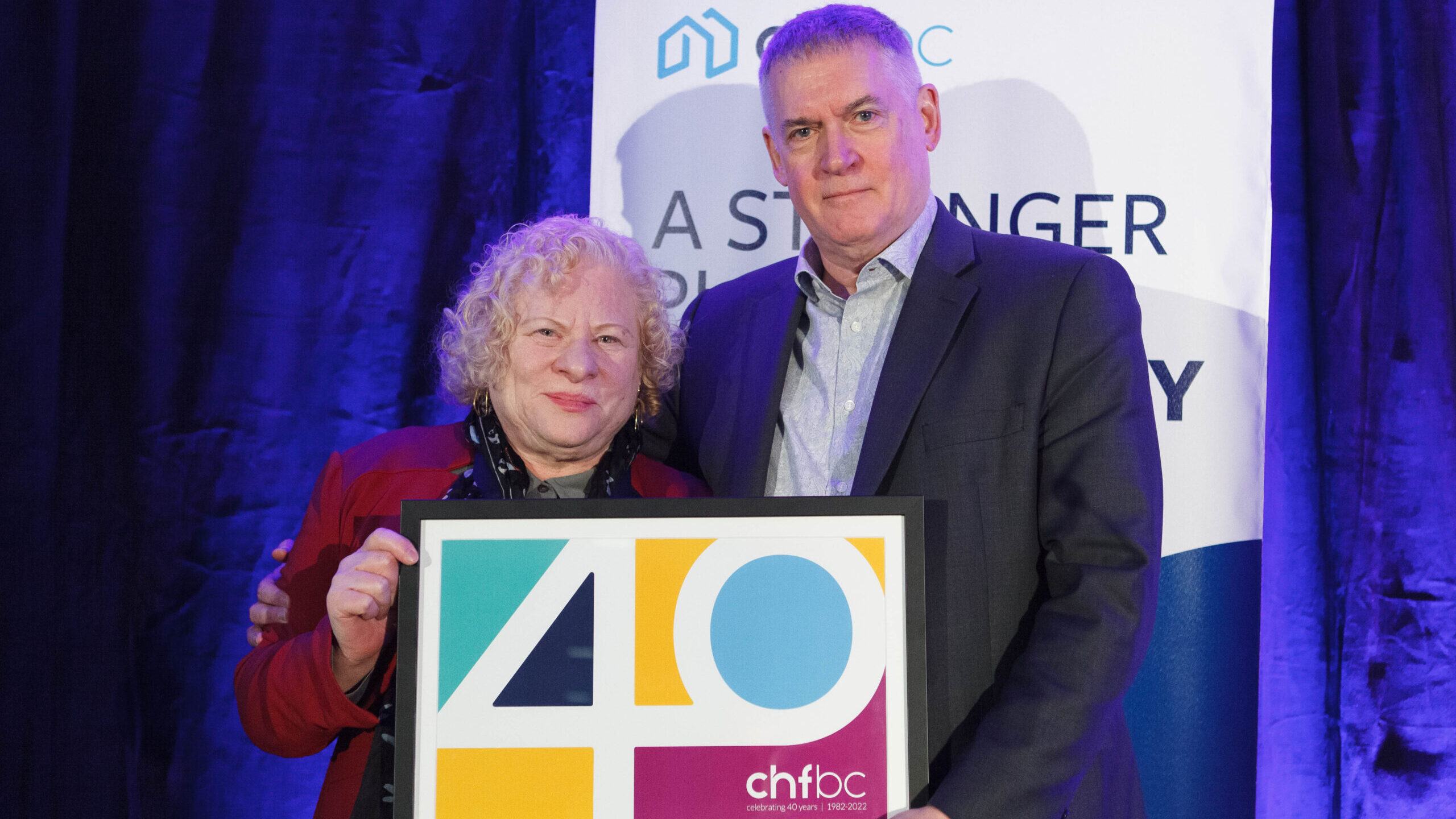 Two people holding a CHF BC 40th anniversary award at the AGM
