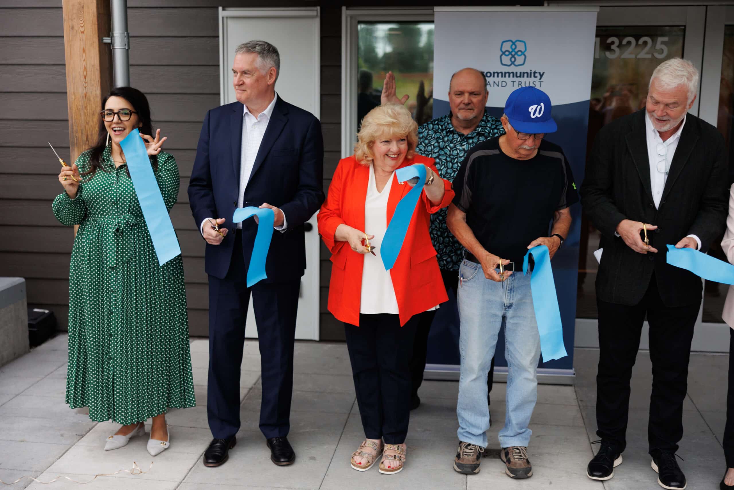 Ribbon-cutting at the grand opening of Sunshine co-op, a Community Land Trust project