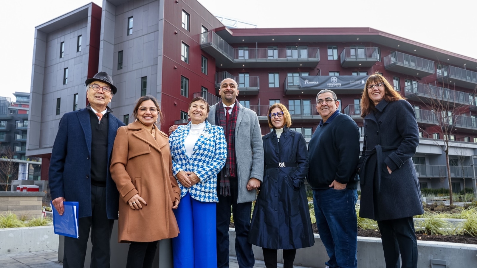Group standing outside the Sawmill housing co-op apartment building